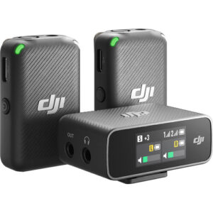 Two DJI drone batteries standing upright beside a compact DJI charger with a digital display show status indicators on the screen and LEDs.