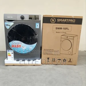 Front-loading washing machine with Steam Wash label on a stand, next to its brown SMARTPRO SWM-10FL box.